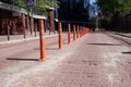 Orange bollard with reflective paint strips on the road. Traffic jam. Road sign. Traffic safety. Empty street. Speed Royalty Free Stock Photo