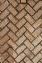 Orange brick herringbone pattern with brown mortar