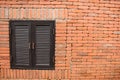 Orange brick wall with brown close window Royalty Free Stock Photo