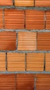 Orange brick wall with cement joining them together