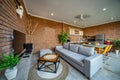 Orange brick walls. Luxury villa in a modern design. Open space dining with pool view next to livign room Royalty Free Stock Photo