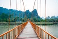 Orange bridge over song river in Vang Vieng, Laos Royalty Free Stock Photo