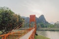 Orange bridge over song river in Vang Vieng,Laos Royalty Free Stock Photo