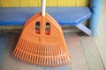 Orange broom. Cleaning tool. Garden tool