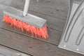 Orange broom and snow shovel in spring