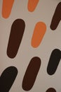 Orange, brown, and black dashes painted on white wall