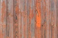 Orange and brown peeling paint with old worn wooden texture of the background fence weathered boards Royalty Free Stock Photo