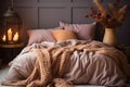 Orange and brown pillows and knitted blanket on bed in natural bedroom interior Royalty Free Stock Photo