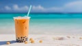 orange bubble tea in front of blurred holiday beach resort in background Royalty Free Stock Photo
