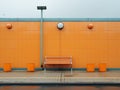 an orange building with a bench sitting in front of it