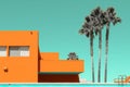 an orange building with palm trees and a pool