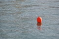 Orange buoy floating on the sea water Royalty Free Stock Photo