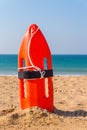 Orange buoy stands in beach sand Royalty Free Stock Photo