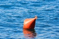 Orange buoy on blue water Royalty Free Stock Photo