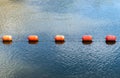 Orange buoys floating on the waterway