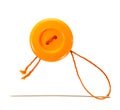 Orange button with thread and needle Royalty Free Stock Photo