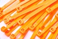 Orange cable ties. Commercial photo on white background.