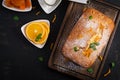 Orange cake with dried apricots and powdered sugar. Royalty Free Stock Photo