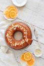 Orange cake served on a white wooden table. Flat lay style Royalty Free Stock Photo