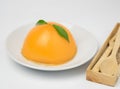Orange cake on white background. environment have fork and spoons.