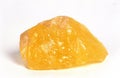 ORANGE CALCITE STONE AGAINST WHITE BACKGROUND