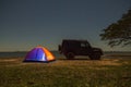 orange camping tent and jeep at night time Royalty Free Stock Photo