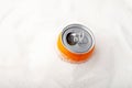 Orange can of sweet carbonated drink and heap of sugar. Top view, selective focus. Concept - Excess Sugar in Soda Fizzy Drinks