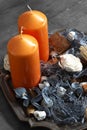 Orange candles with potpourri on an antique metal tray