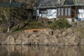 Orange canoe among withered grass on riverbank Royalty Free Stock Photo