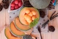 Orange cantaloupe melon fruit juicy on wood background.