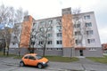 Orange car in front block of flats