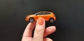 Small car model toy in female hand