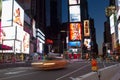 Orange car in motion at Time Square New York City early in the morning Royalty Free Stock Photo