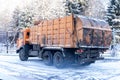 Orange car picking up garbage in the winter season Royalty Free Stock Photo