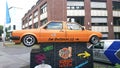 Orange car with two front ends as an welcome ad sign to Halle 77 museum in Dortmund