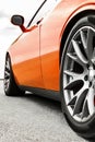 Orange car. Car wheels close up on a background of asphalt. Car tires. Car wheel close-up. for advertising Royalty Free Stock Photo