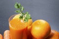 Orange and carrot juice in glass with ginger,