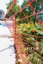 Orange caution fence along a sidewalk