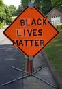 Orange caution sign reinvented to read BLACK LIVES MATTER