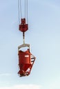 Orange concrete cube hanging with a steel hook Royalty Free Stock Photo