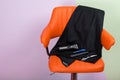 an orange chair on which a set of items is a tool for cutting hair and beard, a variety of scissors, an electric machine and