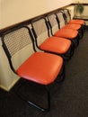 Orange chairs in empty waiting room
