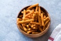 Orange Cheese Flavored Corn Snacks in Stick Shape / Roasted Chips or Salty Crackers in Wooden Bowl. Royalty Free Stock Photo