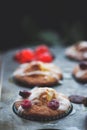 Orange and cherry muffins in muffin baking pan Royalty Free Stock Photo