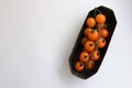 orange cherry tomatoes on a branch on a substrate, minimalism Royalty Free Stock Photo