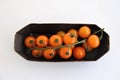 orange cherry tomatoes on a branch on a substrate, minimalism Royalty Free Stock Photo