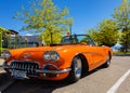 An orange 1959 Chevrolet Corvette Convertible is at summer park. Vintage Chevrolet Corvette a classic cabrio car Royalty Free Stock Photo