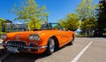 An orange 1959 Chevrolet Corvette Convertible is at summer park. Vintage Chevrolet Corvette a classic cabrio car Royalty Free Stock Photo