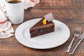 Orange and chocolate cake with cup of coffee on wooden table Royalty Free Stock Photo