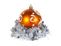 Orange Christmas ball and silver tinsel isolated on white background Royalty Free Stock Photo